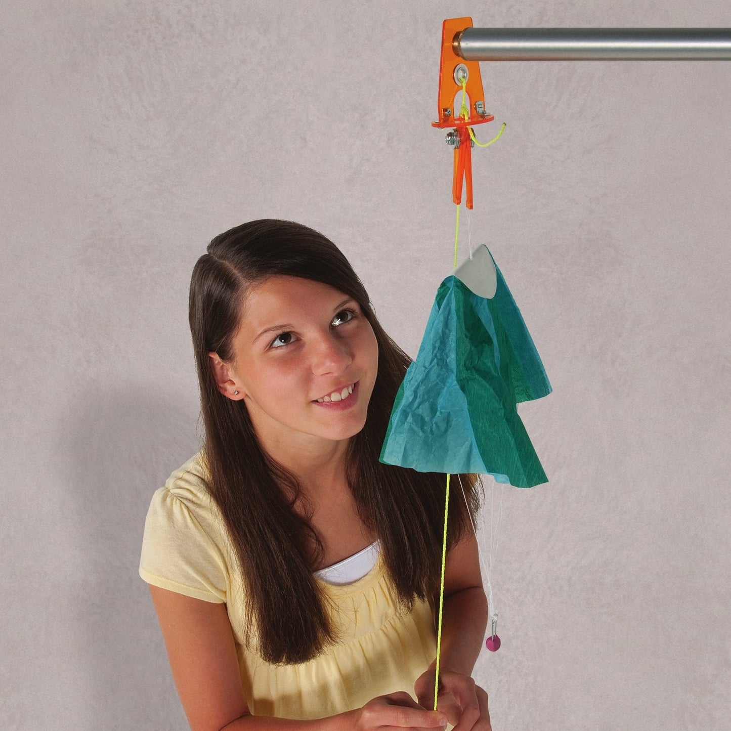 girl testing her parachute model with the rip cord parachute drop