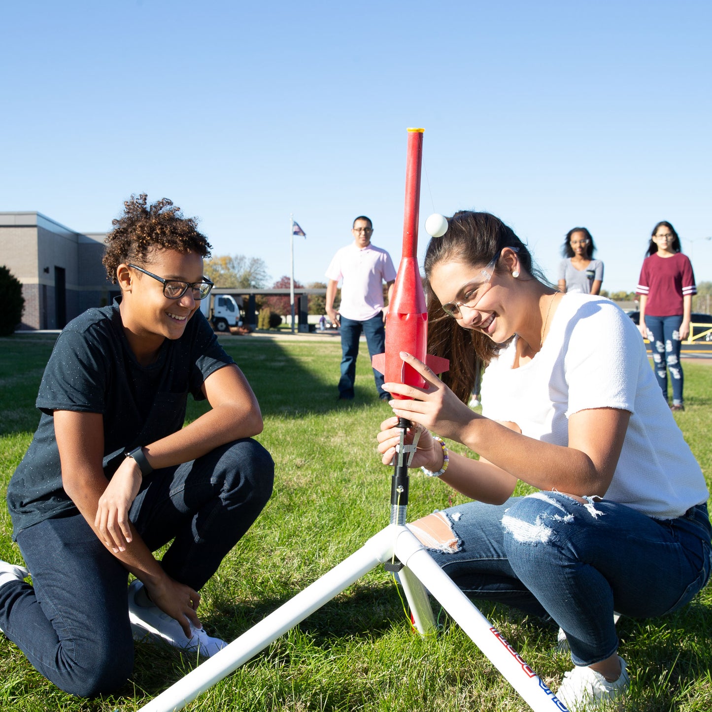 Two students launching a ball using the AquaPort II Water Rocket Launcher
