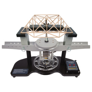 A Structures Testing Instrument with a turn-force wheel and a balsa wood bridge model on top, set on a black base with a digital load cell for measuring force.