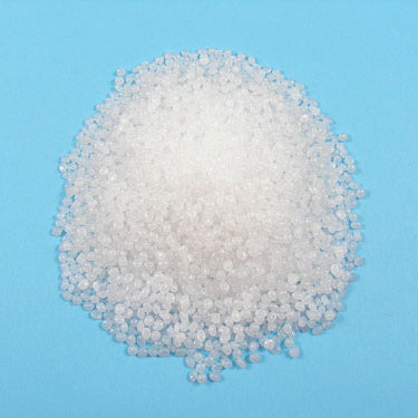 A pile of white thermoplastic polyethylene beads on a blue background.