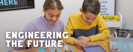 Banner reading Engineering the Future with two smiling students building with small parts and a tablet