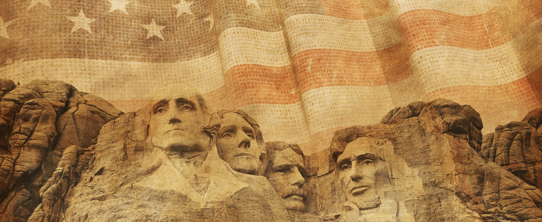 Mount Rushmore carved faces overlaid with a faded American flag in sepia tones