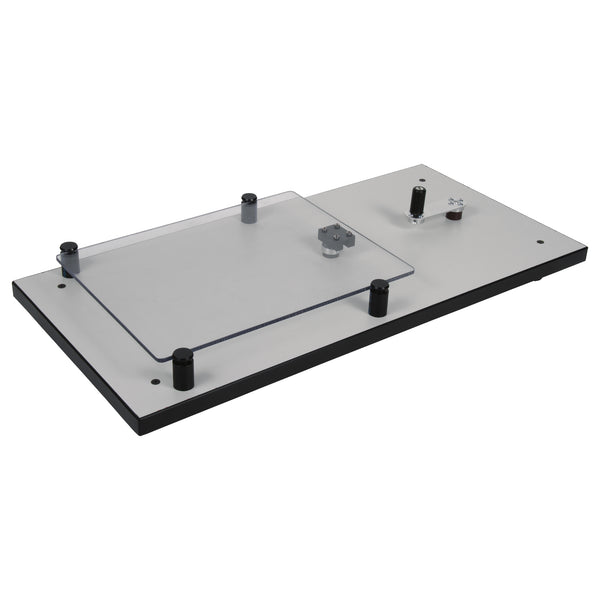A gray shake table with a clear glass top and black supports, designed for educational purposes to simulate earthquakes.