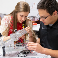 Two students working on a TETRIX MAX robot build in a classroom setting.
