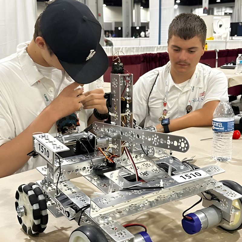 Two young men working on a robot at a table at the SkillsUSA USAR competition